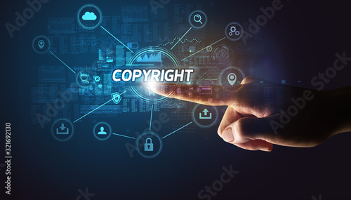 Hand touching COPYRIGHT inscription, Cybersecurity concept