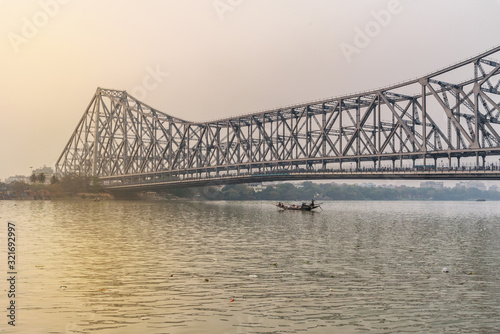 View of Howrah bridge from Mallik ghat on sunset. Kolkata. India photo