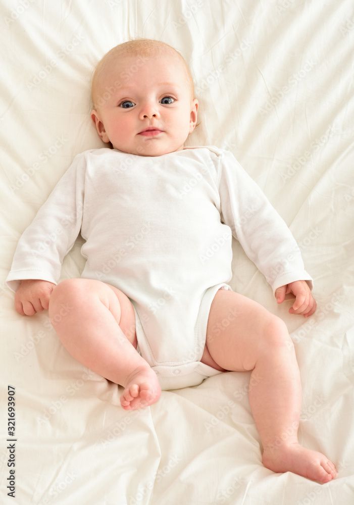 Portrait of a beautiful smiling baby. One. Barefoot.
