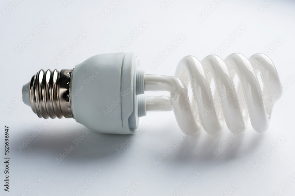 Modern energy-saving spiral lamp on a white background, fluorescent bulb lamp Modern energy-saving spiral lamp on a white background, fluorescent bulb lamp