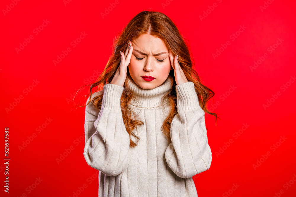 Young upset woman with red hair having headache, studio portrait. Girl putting hands on head, isolated on colorful background. Concept of problems and headache. Young upset woman with red hair having headache, studio portrait. Girl putting hands on head, isolated on colorful background. Concept of problems and headache.