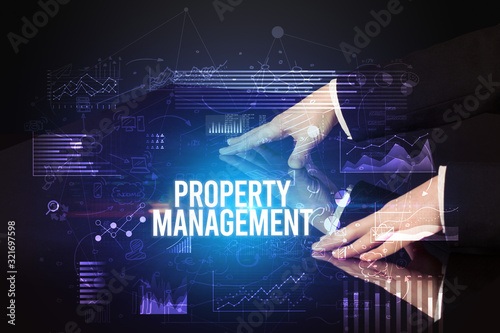 Businessman touching huge screen with PROPERTY MANAGEMENT inscription, cyber business concept © ra2 studio
