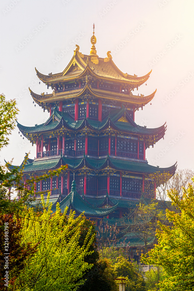 Spring day in the Hongensi forest park. Sun rays. Haze. Hongen Temple in the Chinese city of Chongqing. Place for text.