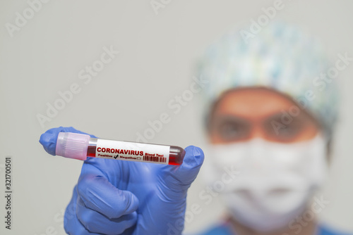 Nurse holding test tube with blood for 2019-nCoV analyzing. Coronavirus positive blood in laboratory. Virus infection originating in Wuhan, China