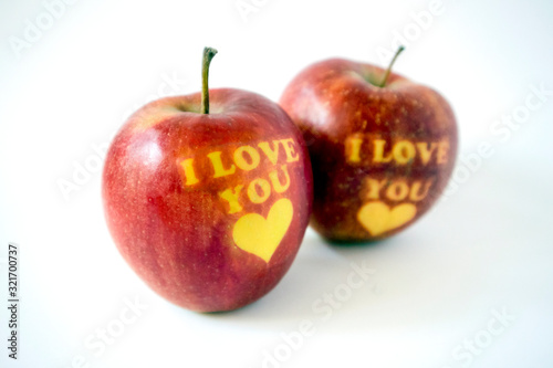 Two red apples with the words I love you