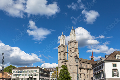 Close view of the Grossmuenster (Grossmunster) church and Wasserkirche (Water Church) on Limmat river side from the Muenster bridge on sunny summer day in Zurich, Switzerland photo