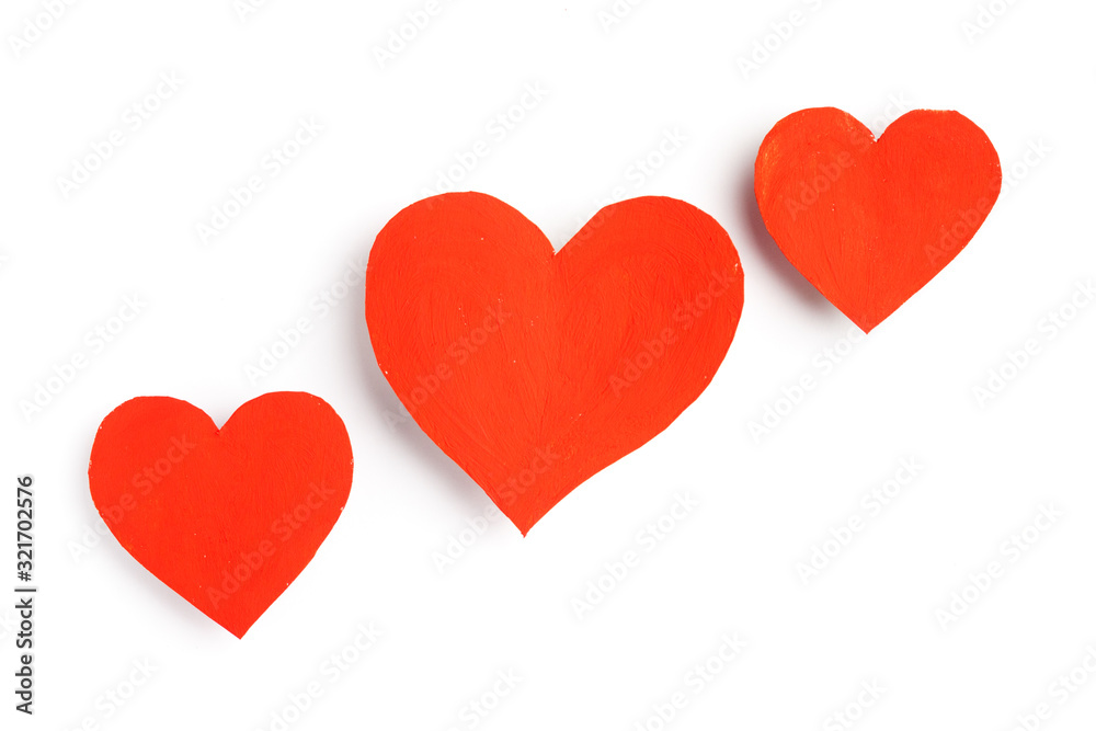 Cute red hearts lie on a white background.