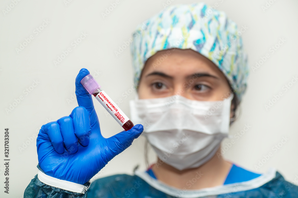 Nurse holding test tube with blood for 2019-nCoV analyzing. Virus infection originating in Wuhan, China Nurse holding test tube with blood for 2019-nCoV analyzing. Virus infection originating in Wuhan, China