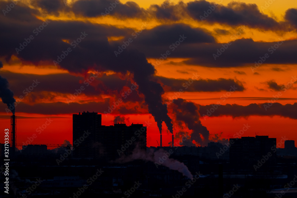 industrial center at sunset with chimneys and smoke