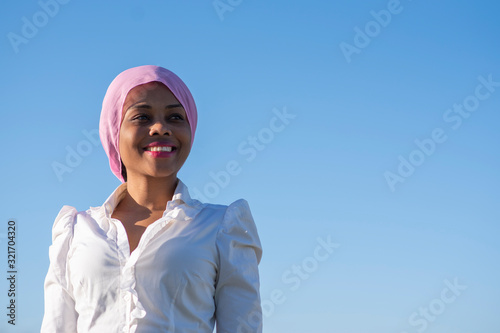 Beautiful smiling African-American woman with a pink headscarf