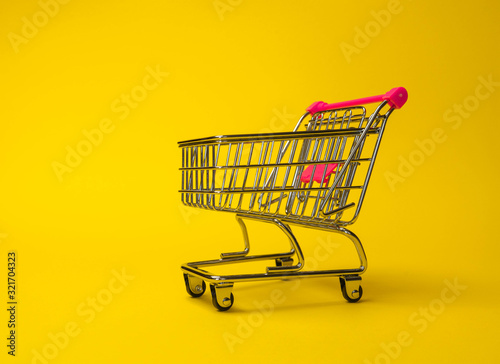isolated empty shopping cart in a typical studio setup. This image contains clipping path for exact isolation from the background