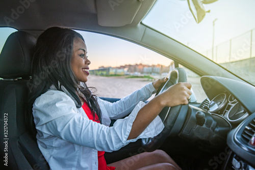 Beautiful smiling African-American woman driving a car © satur73