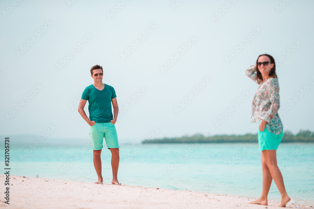 Young couple on white beach during summer vacation. Young couple on white beach during summer vacation.