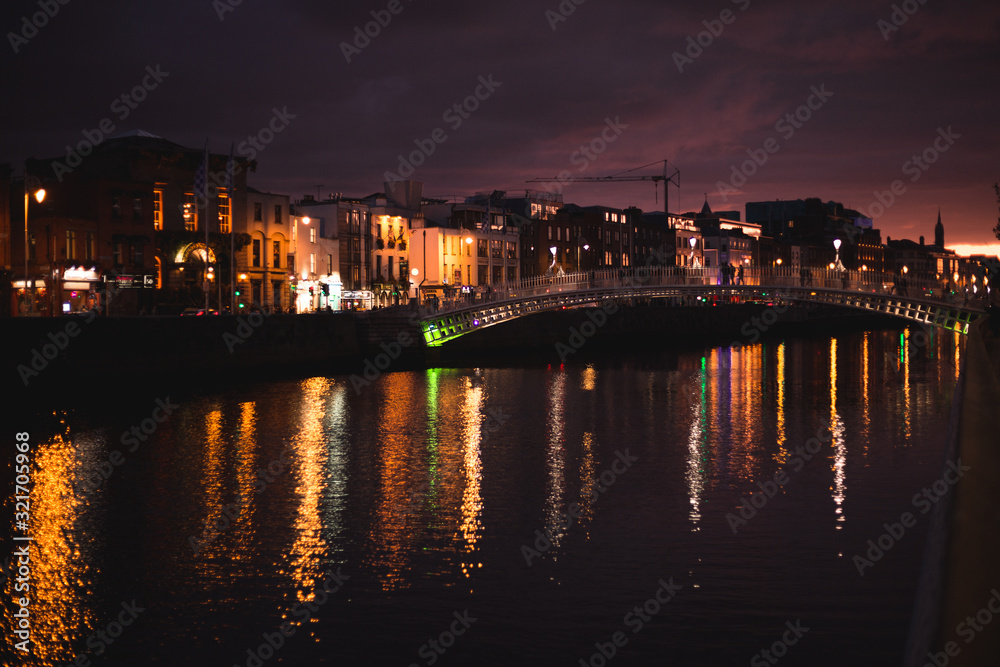 Dublin's night cityscape with bridge over Liffey river