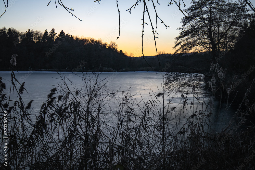 scenics sunset in winter season on a frozen lake