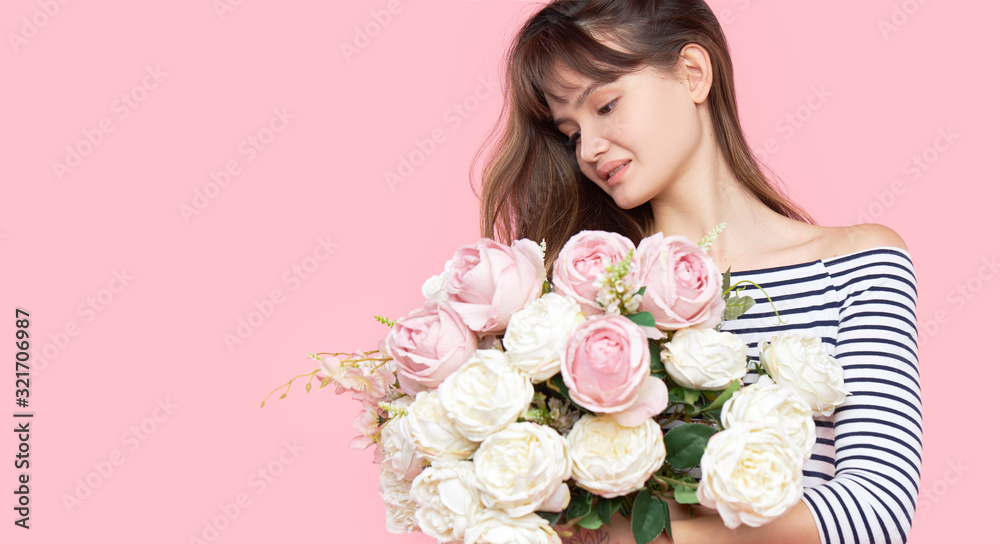 Beautiful Asian girl holds a beautiful lush bouquet in her hands on a light background. Banner, Copy space for text Beautiful Asian girl holds a beautiful lush bouquet in her hands on a light background. Banner, Copy space for text