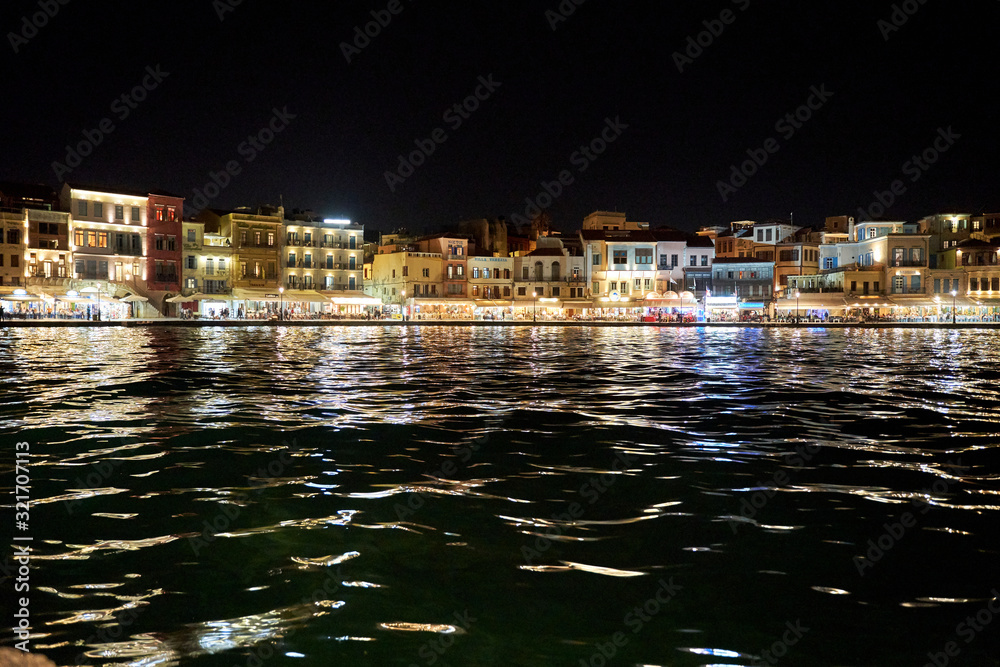 venetian harbour lighthouse in Chania, Crete, Greece at night