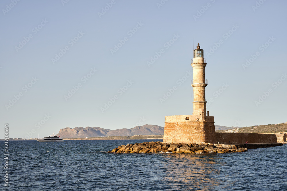 Lighthouse in old harbour of Chania at sunset, Crete, Greece