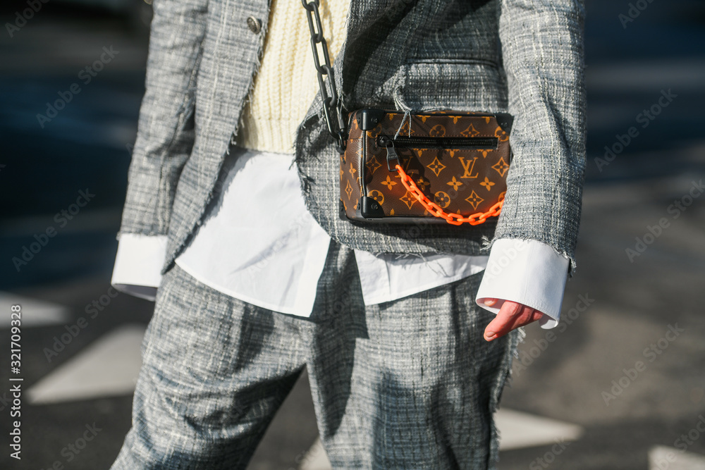 Milan, Italy – January 11, 2020: Fashionable man with Louis Vuitton hand  bag, street style outfit. Stock Photo