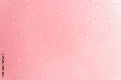 light drops on a pink background. texture for product advertise