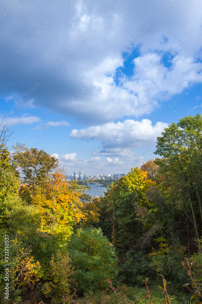 City of Kiev, Ukraine. City landscape overlooking the Dnieper river, parks and builds. Fluffy clouds and sunny autumn day. City of Kiev, Ukraine. City landscape overlooking the Dnieper river, parks and builds. Fluffy clouds and sunny autumn day.