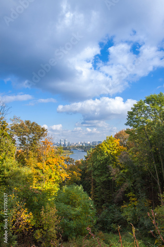 City of Kiev, Ukraine. City landscape overlooking the Dnieper river, parks and builds. Fluffy clouds and sunny autumn day.