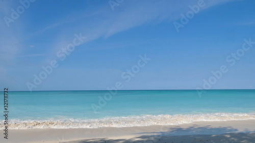 Beautiful empty beach in Tanzania with blue water on a sunny day with no clouds