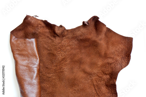 Leather in roll isolated on white background. Piece of brown leather isolated on white
