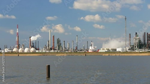 A large oil refinery in the harbor of Antwerp, Belgium with perfect blue sky.
