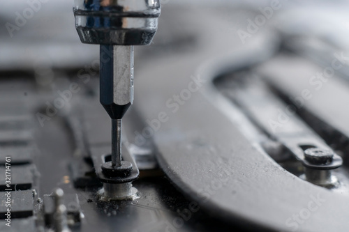 macro view small screwdriver screw and repair the detail inside the computer