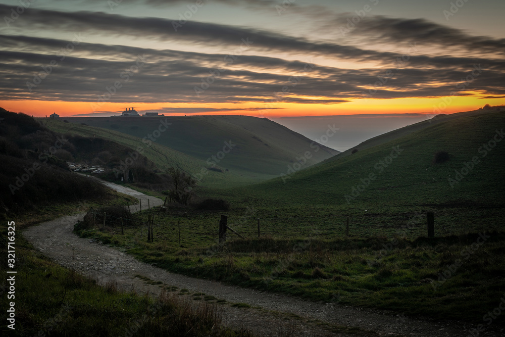 Beautiful vibrant sunset over country road and clifftop Beautiful vibrant sunset over country road and clifftop