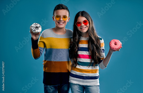 Fashionable boy and cute girl on a blue background