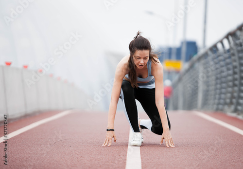Fitness sport girl on intensive evening run, attractive runner jogging outdoors, female jogger in bright sportswear. © Alexander