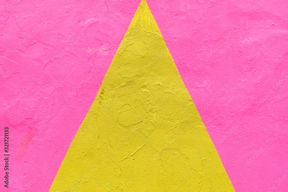 Abstract plaster texture of a yellow triangle on a pink background.