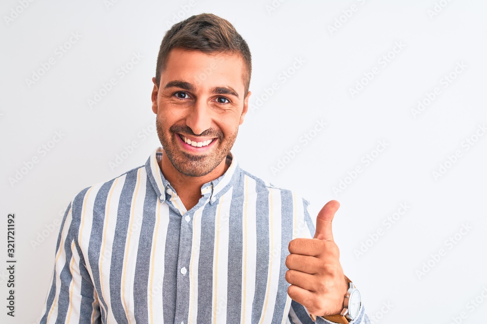Young handsome business man wearing elegant shirt over isolated background doing happy thumbs up gesture with hand. Approving expression looking at the camera with showing success. Young handsome business man wearing elegant shirt over isolated background doing happy thumbs up gesture with hand. Approving expression looking at the camera with showing success.