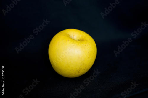 yellow apple on black