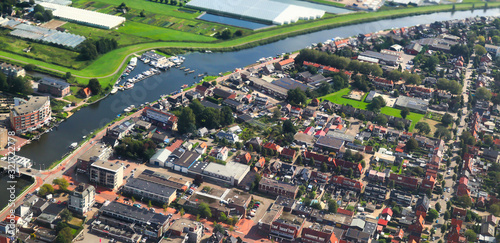 Aerial view of European classical styled with river and cultivated agricultural farming land shot from the air