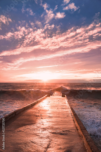 Fototapeta Naklejka Na Ścianę i Meble -  The evening sea is stormy. Sea sunset. The violence of the elements. Sea foam. Incredibly beautiful colors.