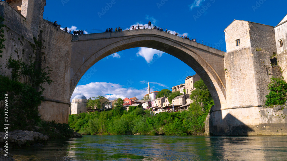 Mostar, Bosnia and Herzegovina, April 2019: Old town and Neretva River. The town was destroyed during the Croat-Bosniak war in 1993, reconstructed and now a UNESCO World Heritage