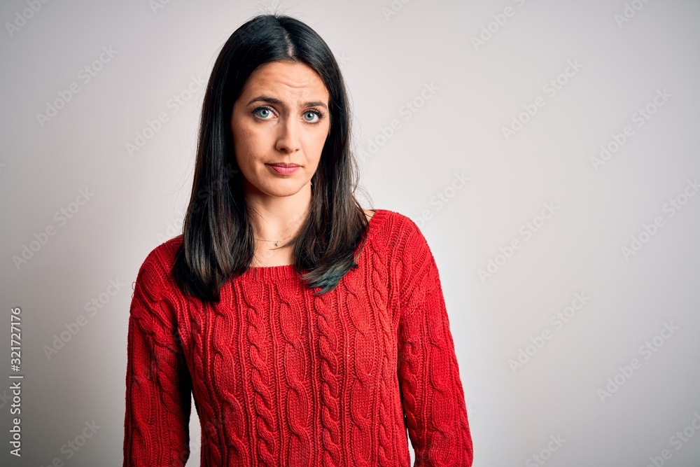 Young brunette woman with blue eyes wearing casual sweater over isolated white background looking sleepy and tired, exhausted for fatigue and hangover, lazy eyes in the morning. Young brunette woman with blue eyes wearing casual sweater over isolated white background looking sleepy and tired, exhausted for fatigue and hangover, lazy eyes in the morning.