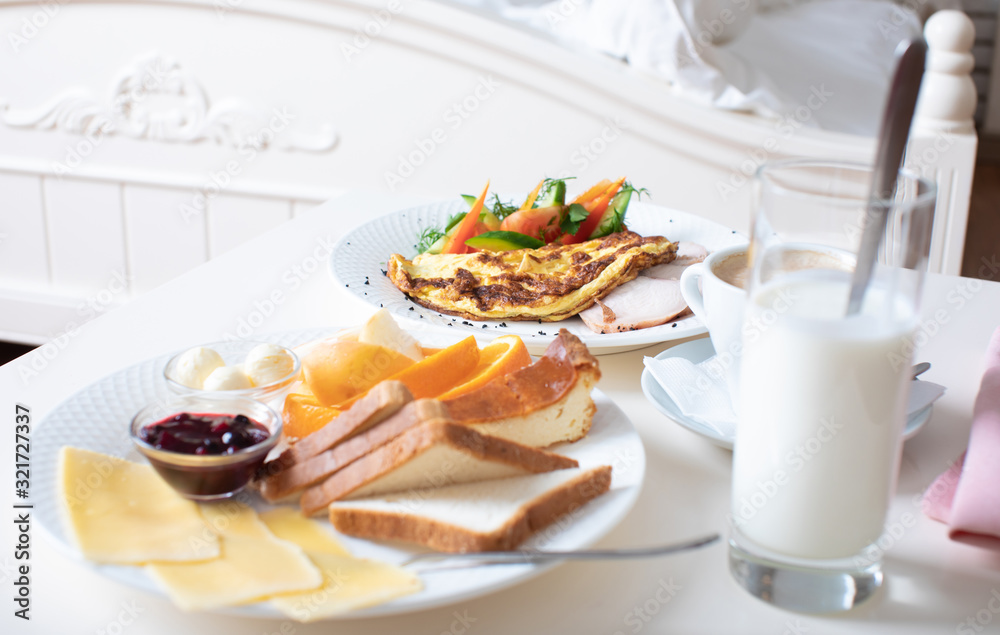 Close-up of tray with tasty breakfast on a bed.