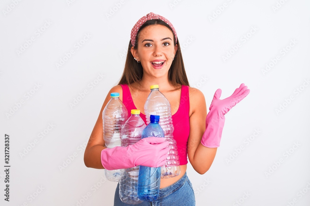 Beautiful girl wearing cleaner gloves recycling plastic bottles over isolated white background very happy and excited, winner expression celebrating victory screaming with big smile and raised hands Beautiful girl wearing cleaner gloves recycling plastic bottles over isolated white background very happy and excited, winner expression celebrating victory screaming with big smile and raised hands