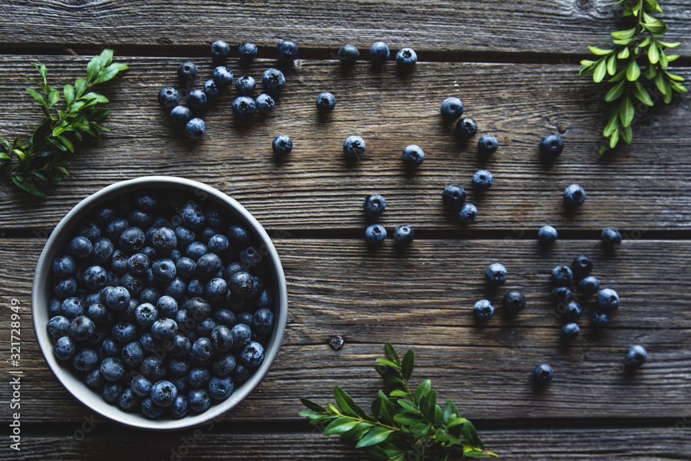 Bowl of blueberries on a wooden background. Healthy food, health Bowl of blueberries on a wooden background. Healthy food, health