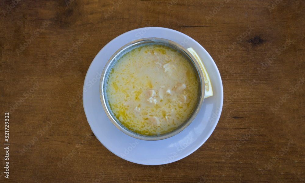 Tripe soup in a bowl / plate with lemon on wooden table background. Traditional soup of Gaziantep, Turkey. Famous symbol Turkish cuisine fresh food foams. Veal meat ingredients in regional soup. Khash Tripe soup in a bowl / plate with lemon on wooden table background. Traditional soup of Gaziantep, Turkey. Famous symbol Turkish cuisine fresh food foams. Veal meat ingredients in regional soup. Khash