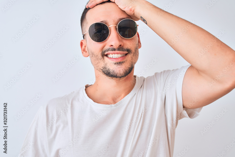Young handsome man wearing sunglasses and casual t-shirt over isolated background stressed with hand on head, shocked with shame and surprise face, angry and frustrated. Fear and upset for mistake. Young handsome man wearing sunglasses and casual t-shirt over isolated background stressed with hand on head, shocked with shame and surprise face, angry and frustrated. Fear and upset for mistake.