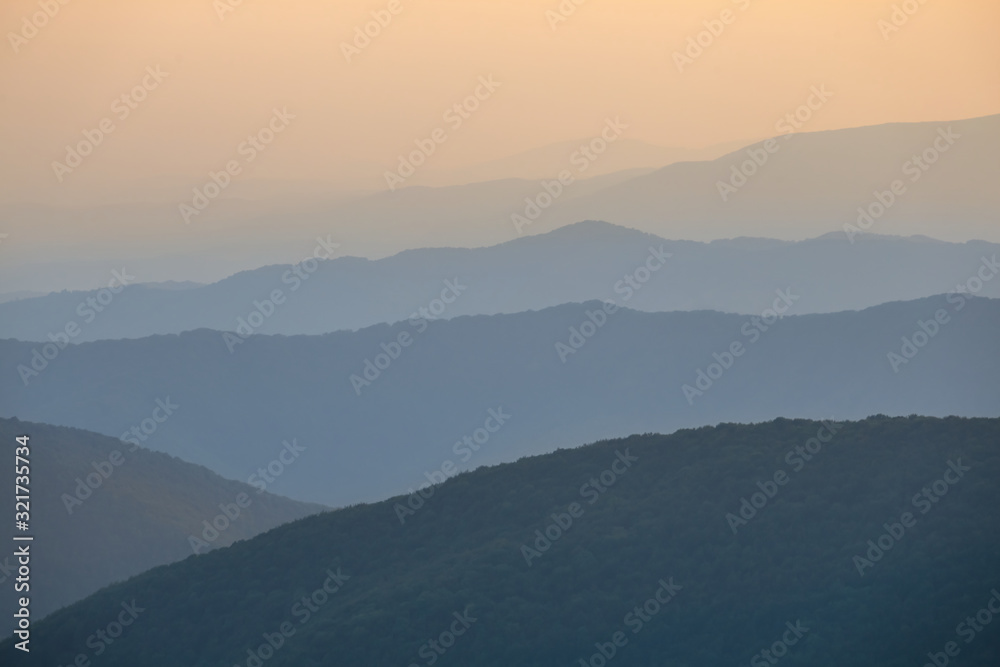 mountain ridge silhouette in a blue mist at the twilight mountain ridge silhouette in a blue mist at the twilight
