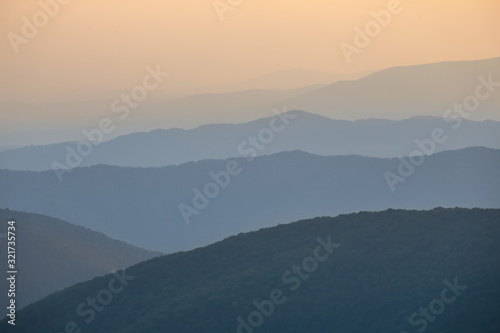 mountain ridge silhouette in a blue mist at the twilight