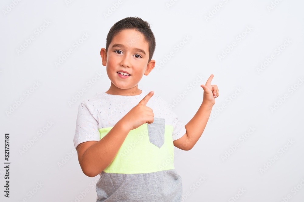 Beautiful kid boy wearing casual t-shirt standing over isolated white background smiling and looking at the camera pointing with two hands and fingers to the side. Beautiful kid boy wearing casual t-shirt standing over isolated white background smiling and looking at the camera pointing with two hands and fingers to the side.