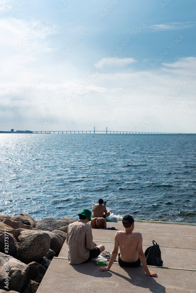 People sunbathing on the promenade in Malmo, Sweden People sunbathing on the promenade in Malmo, Sweden
