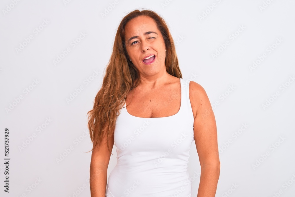 Middle age mature woman standing over white isolated background winking looking at the camera with sexy expression, cheerful and happy face. Middle age mature woman standing over white isolated background winking looking at the camera with sexy expression, cheerful and happy face.